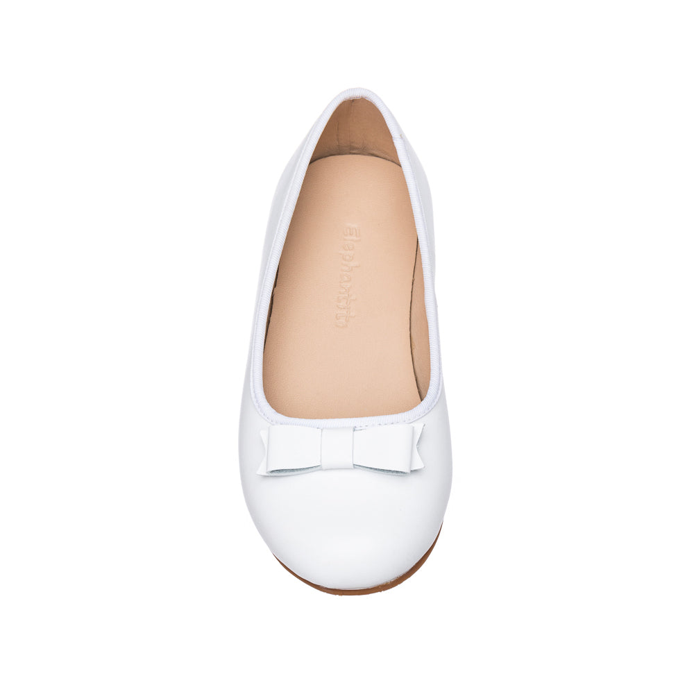 White leather ballet flat for kids with a small decorative bow on top.