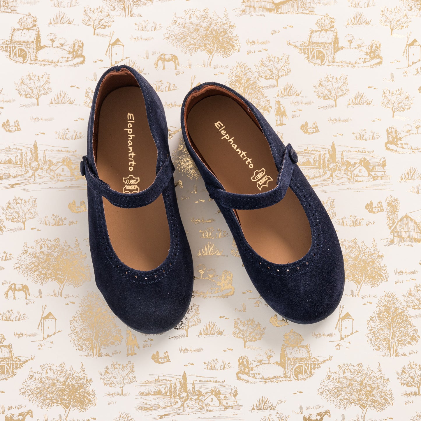 Navy blue suede Mary Jane toddler shoes with velcro strap and scalloped edging.