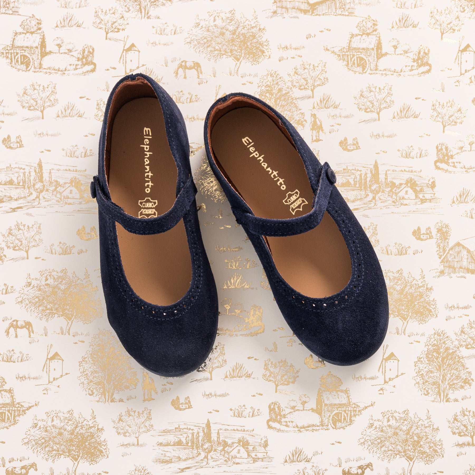 Navy blue suede Mary Jane toddler shoes with velcro strap and scalloped edging.