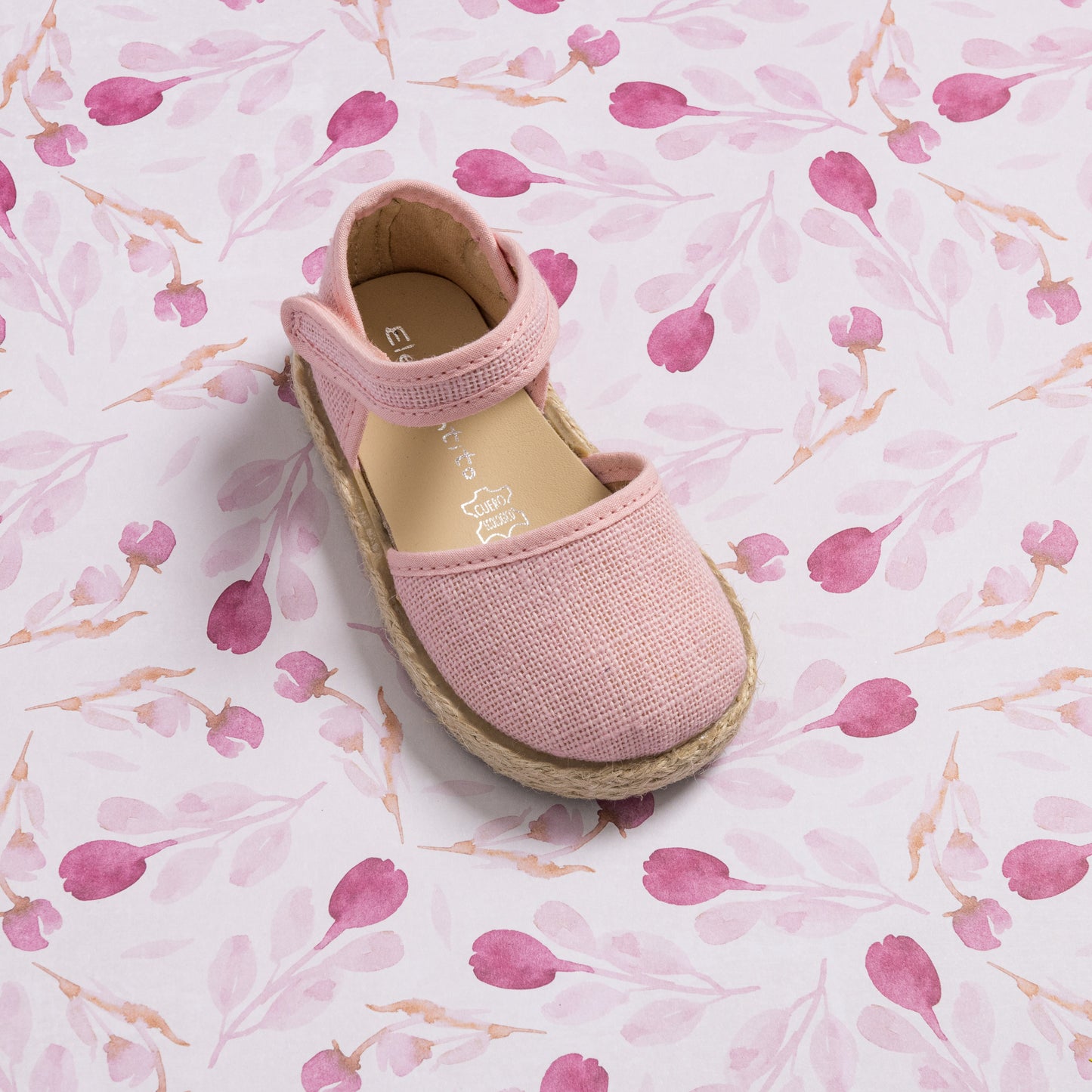 Pink linen espadrille sandal for toddlers with ankle strap and braided jute sole.