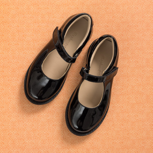 Black patent leather Mary Jane shoes with a round toe and Velcro strap for kids.