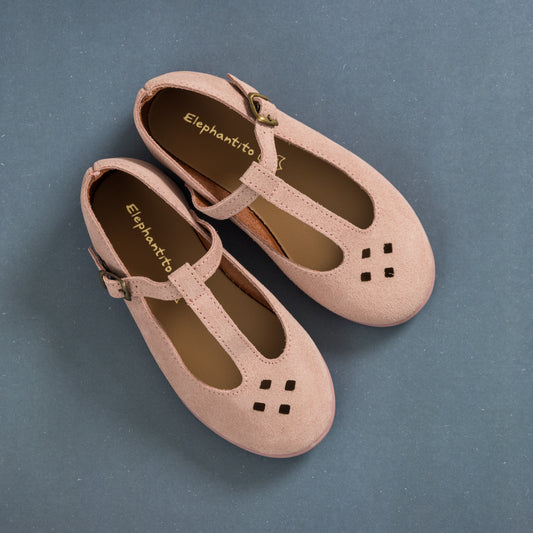 Pink suede T-bar toddler shoes with cutout details and adjustable buckle straps.