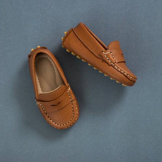 Tan toddler driver loafers with pebble-grain leather and moccasin stitching.