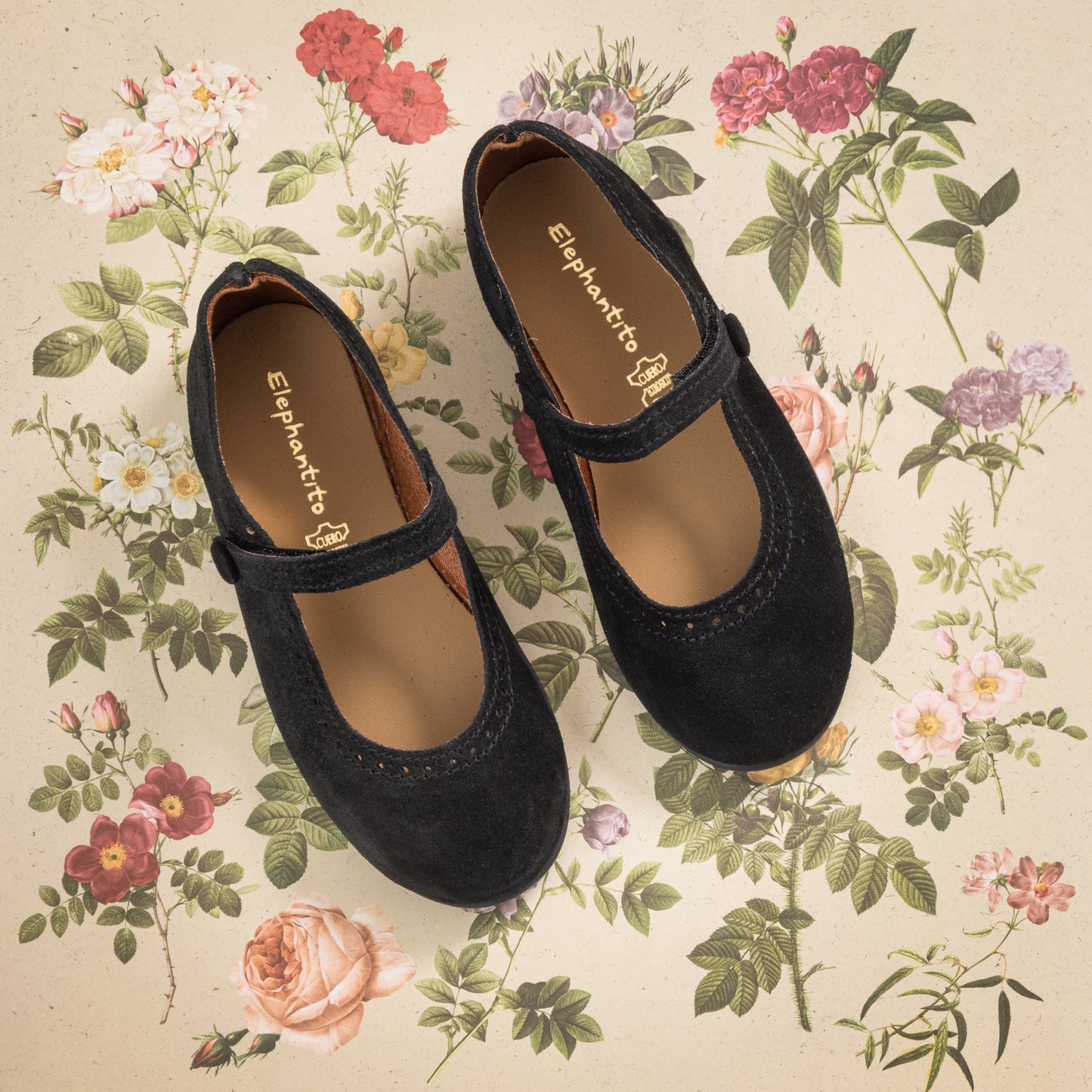Black suede Mary Jane shoes for toddlers with a velcro strap and scalloped edge detailing.