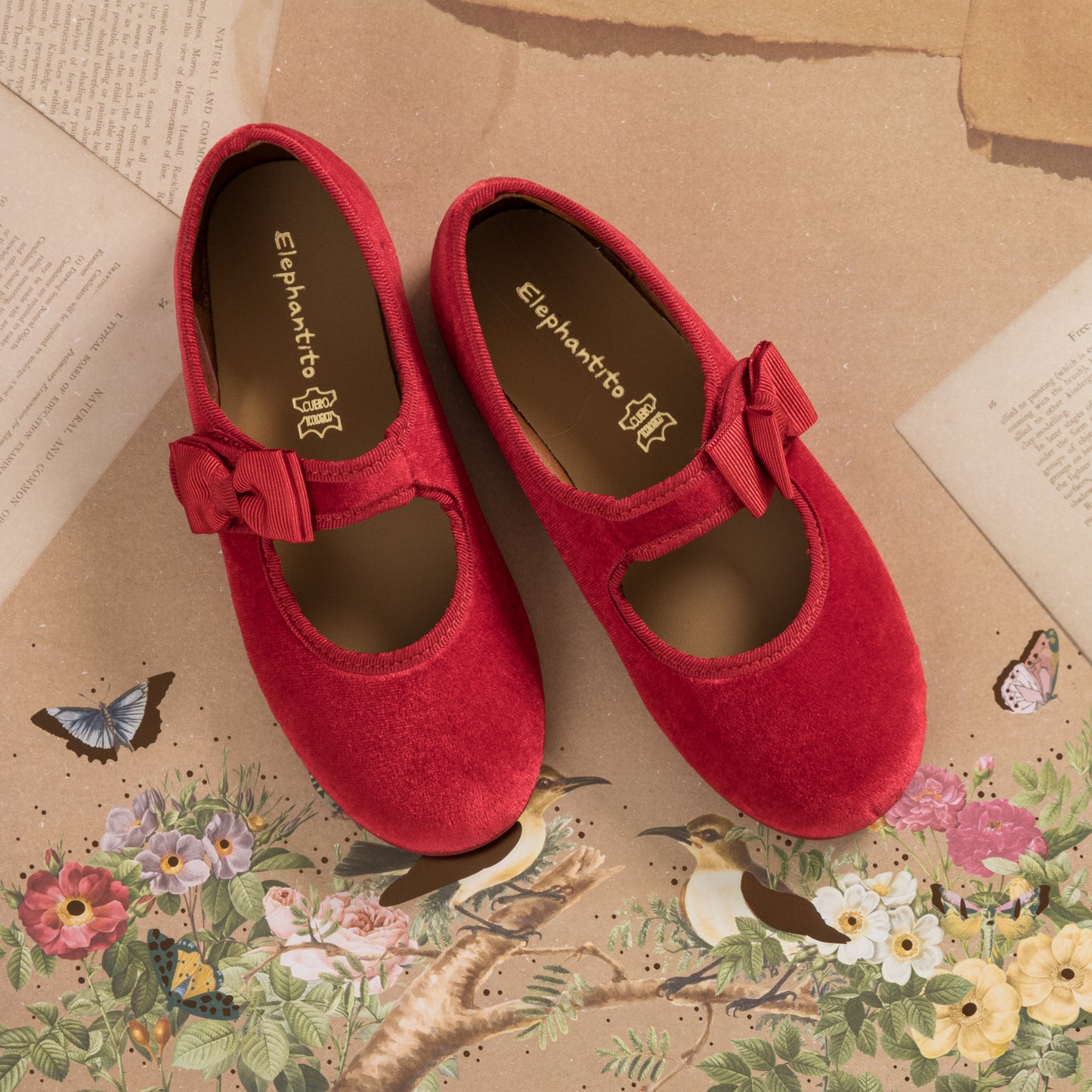 Red velvet Mary Jane shoes with a bow detail and rounded toe for toddlers and kids.