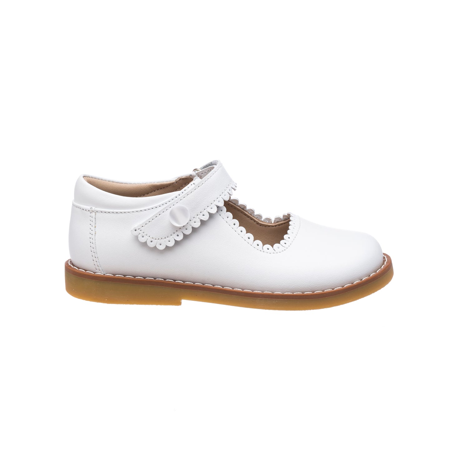 White leather Mary Jane shoe for girls with scalloped edge strap and tan sole.
