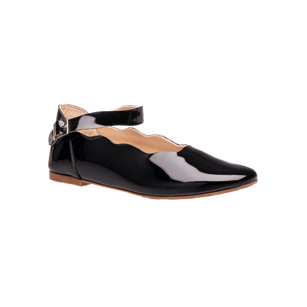 Black patent leather flat with scalloped edges and ankle strap buckle for children.