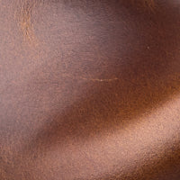 Smooth Apache brown leather with subtle natural grain and warm tone close-up.