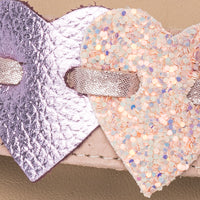 Pink girls sandal strap featuring textured and glittery heart accents in varying shades of pink.