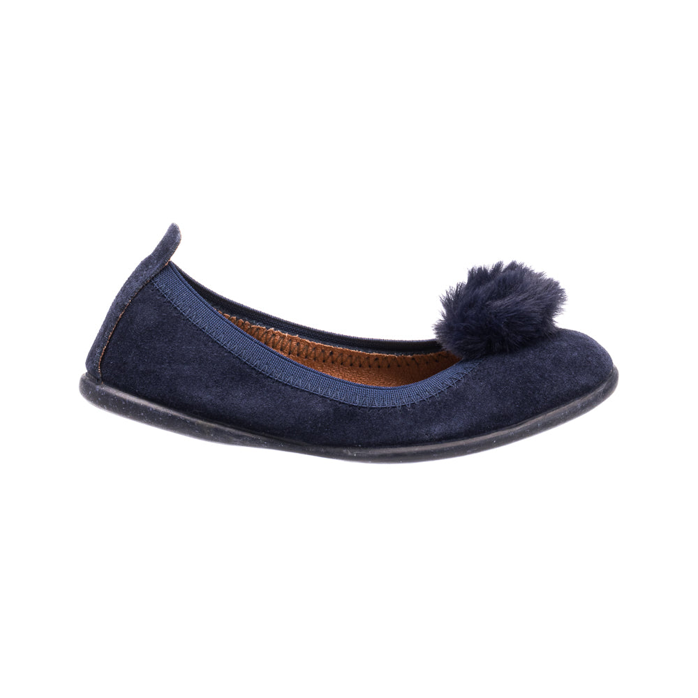 Navy blue suede ballerina shoe with a fluffy pom pom on top and textured interior lining.