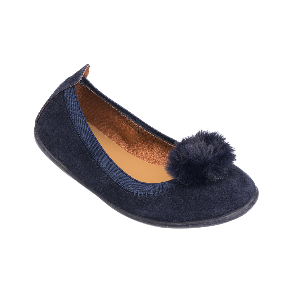 Navy blue suede ballerina flat for kids with a soft pom pom on top and tan inner lining.