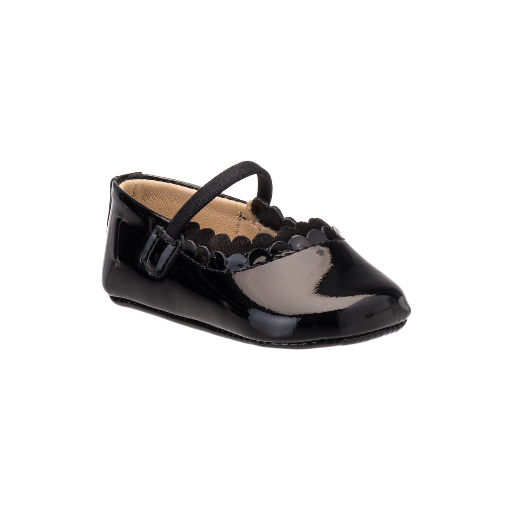 Black patent leather baby ballet flat with scalloped edge and adjustable strap.