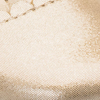 Close-up of textured shiny gold fabric with detailed stitching, likely part of baby ballet shoes.