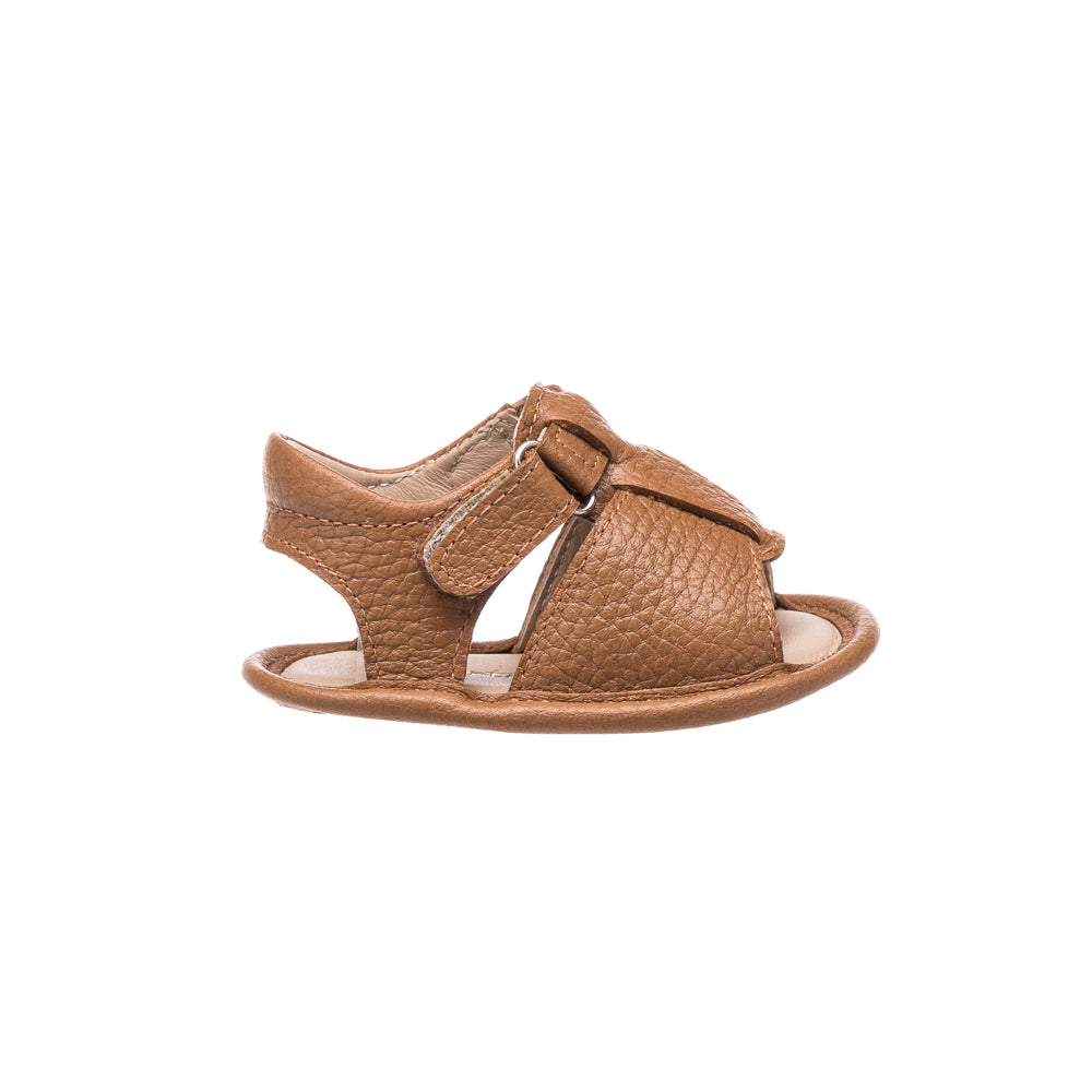 Caramel brown baby boy sandal with textured leather and adjustable side strap.