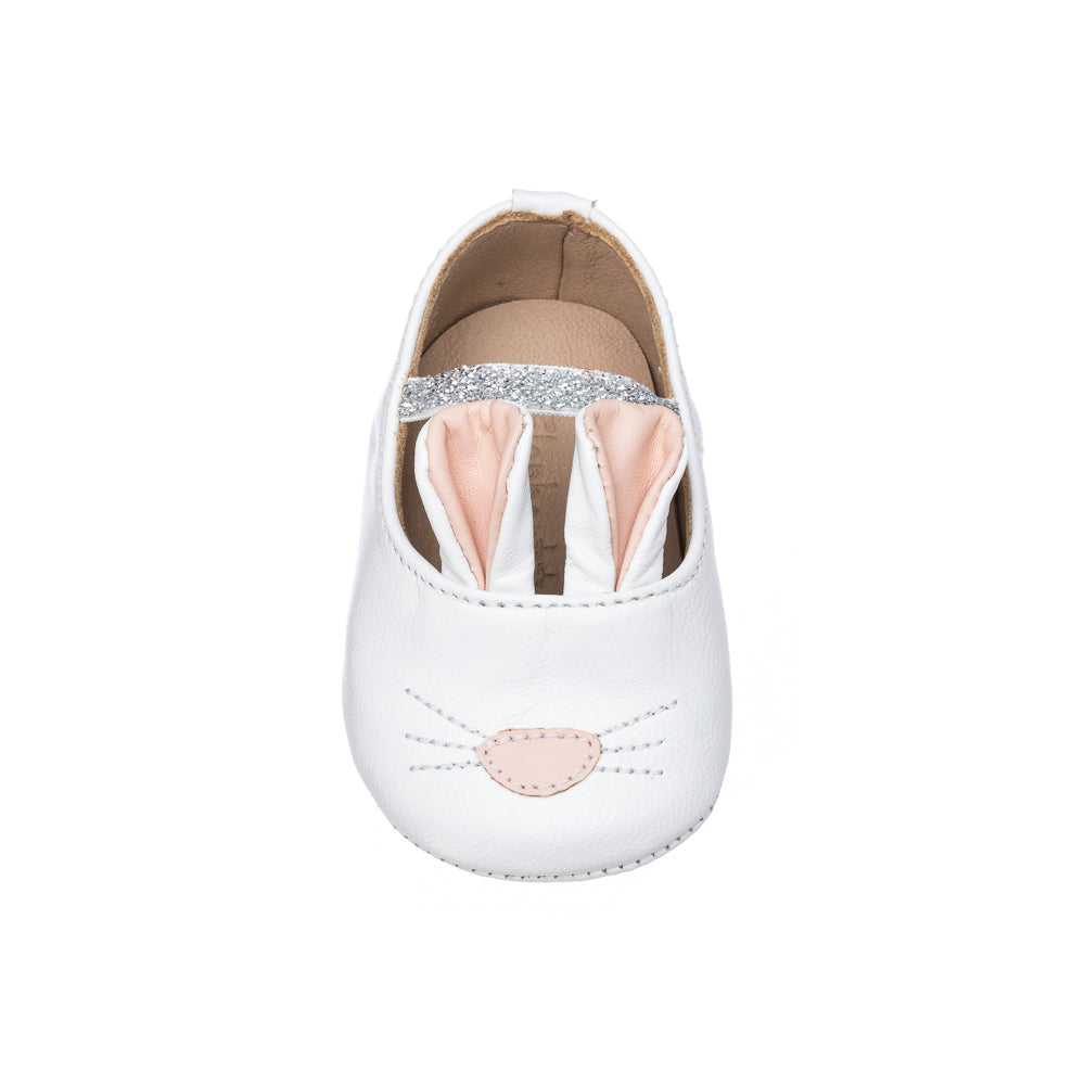 White baby slipper with soft pink bunny ears and embroidered nose and whiskers.