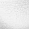 White textured leather close-up showing grain detail on baby Mary Jane shoe.