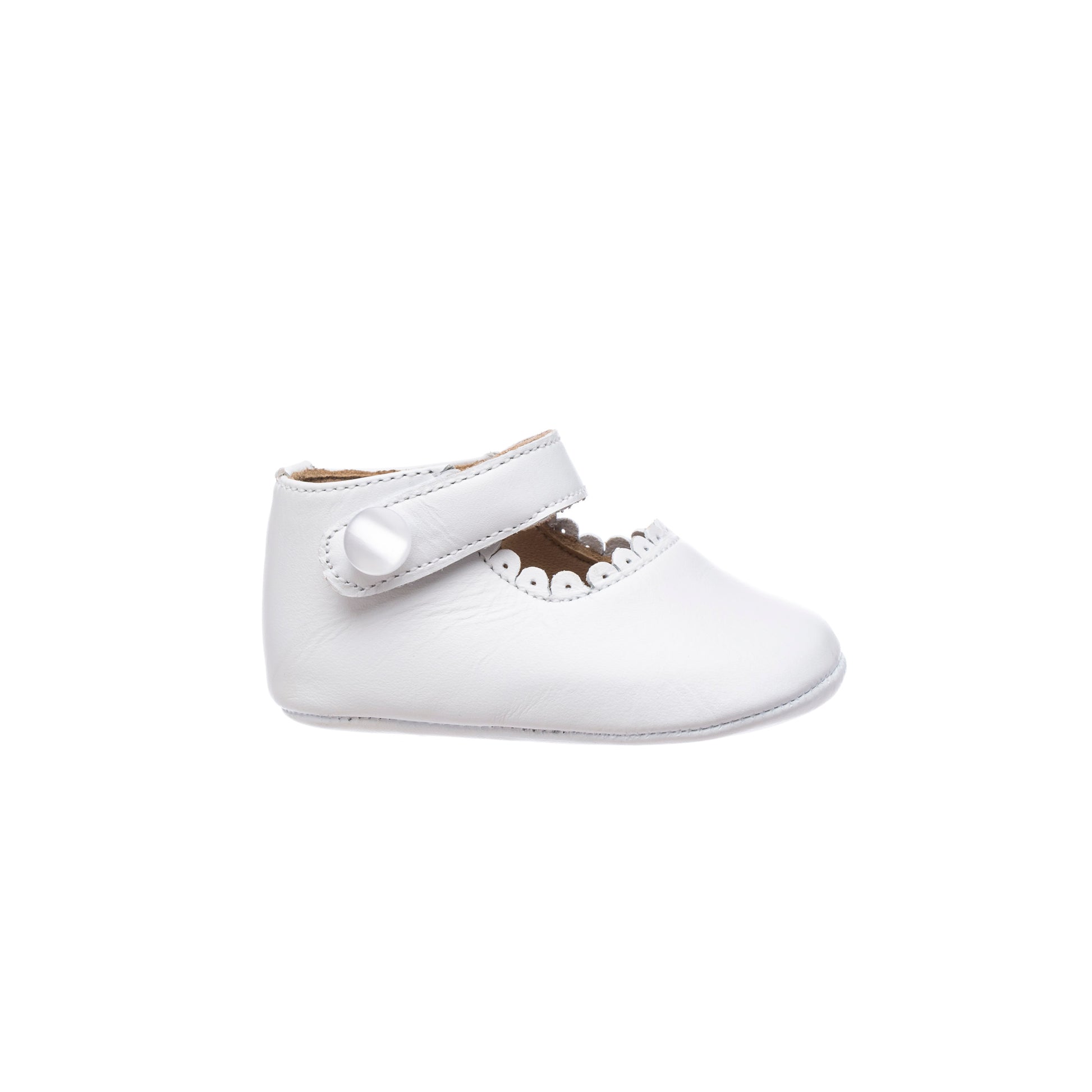White baby Mary Jane shoe with scalloped edge and single velcro strap closure.