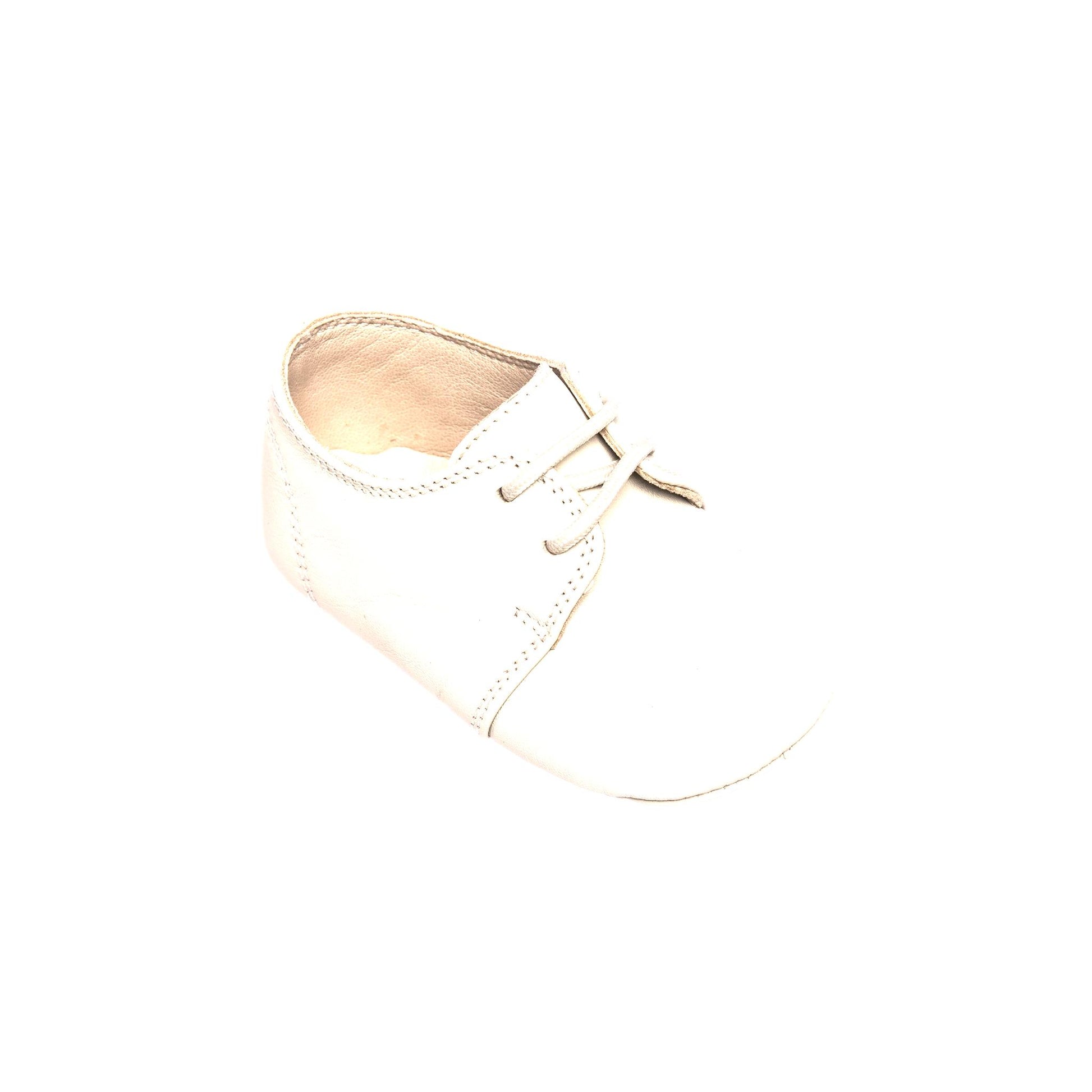 Soft white baby oxford shoe with lace-up closure and smooth leather material.