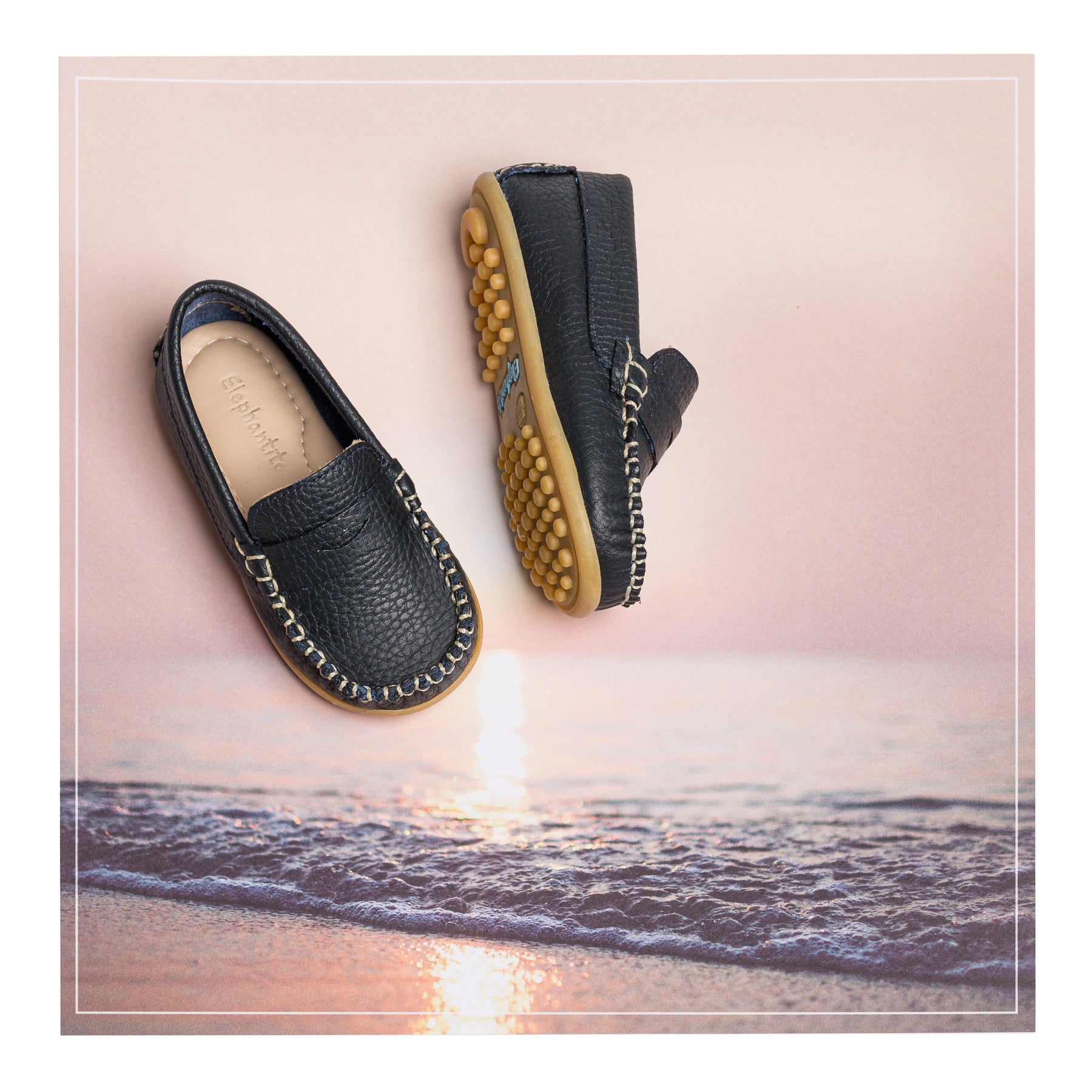 Toddlers black slip-on leather driving shoes with rubber sole and stitched detailing.
