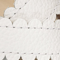 Elephantito - White textured leather sandal with scalloped edges and black stitching details.