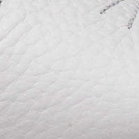 White baby slipper with a bunny ear design and soft textured material.