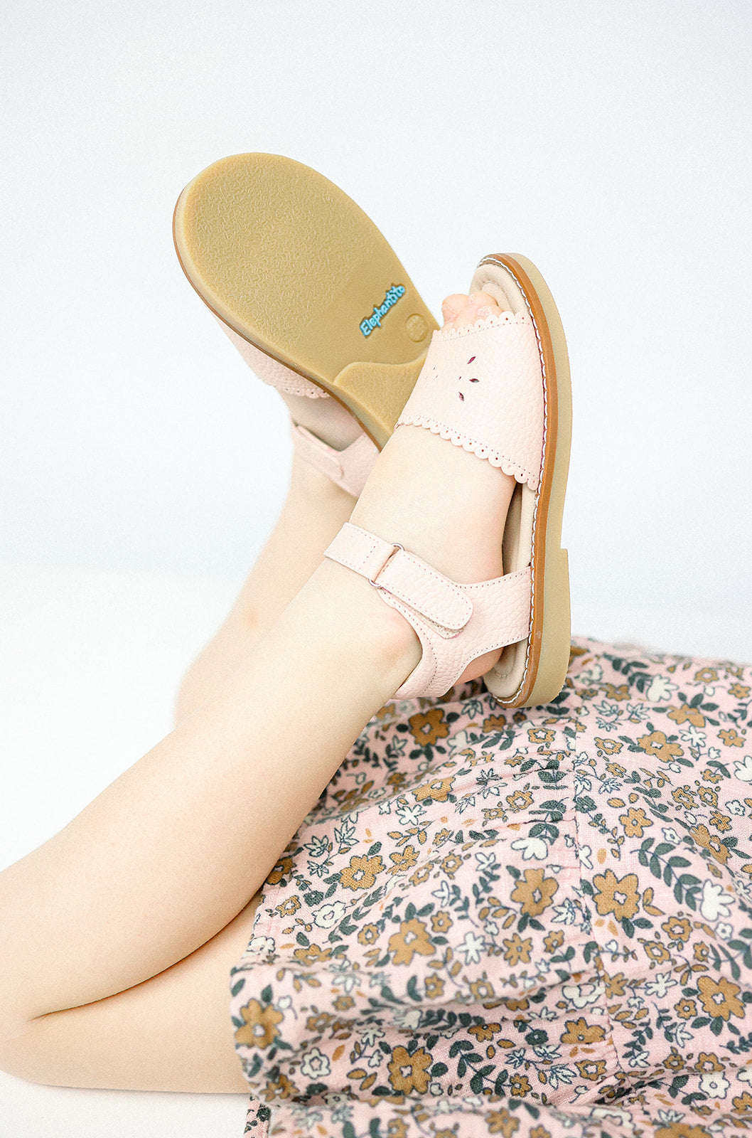 Pink scalloped edge toddler sandal with adjustable strap and soft sole.