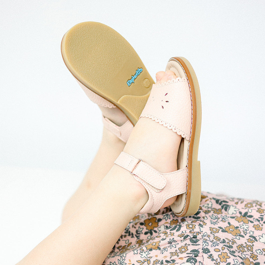 Pink scalloped edge toddler sandal with adjustable strap and soft sole.