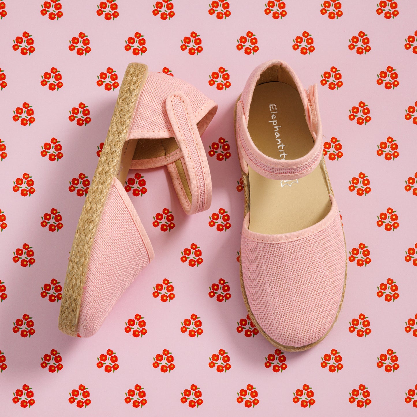 Elephantito - Pink linen espadrille with ankle strap and jute sole on floral background.