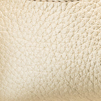 Close-up of soft, textured gold leather with a subtle metallic sheen and fine grain pattern.