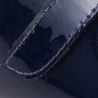 Glossy navy blue patent leather Mary Jane shoe with neat stitching detail.