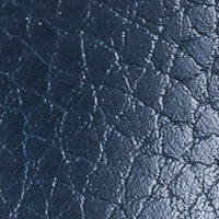 Navy blue textured leather close-up with subtle grain detail, toddler shoe material.