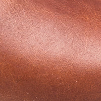 Close-up of natural brown smooth leather texture on boy’s sandal.