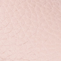 Textured light pink leather surface with subtle pebble grain pattern.