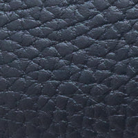 Textured navy blue leather with a pebble grain finish on children's slip-on shoe.