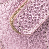 Close-up of pink textured leather toddler sandal strap with metallic shimmer and detailed stitching.