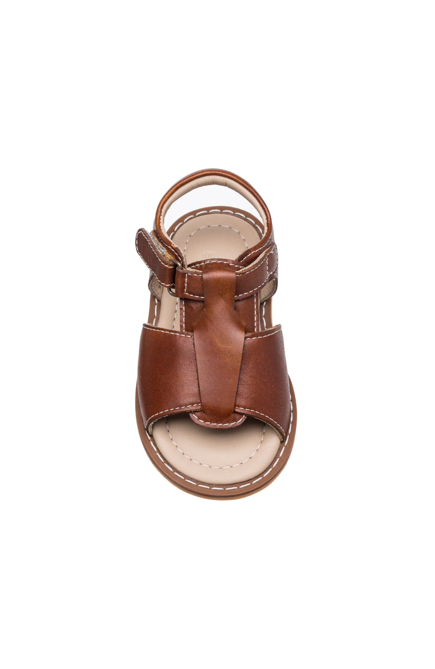 Brown leather toddler sandal with closed toe and adjustable ankle strap on beige sole.