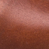 Close-up of smooth brown leather sandal material with subtle natural texture.