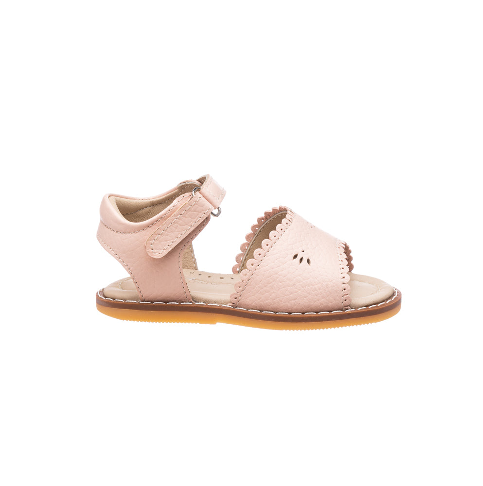 Pink toddler sandal with scalloped edges and ankle strap on tan sole.