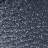 Navy blue textured leather close-up with pebble grain finish.