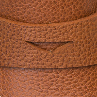 Close-up of tan textured leather toddler loafer with stitched strap detail.