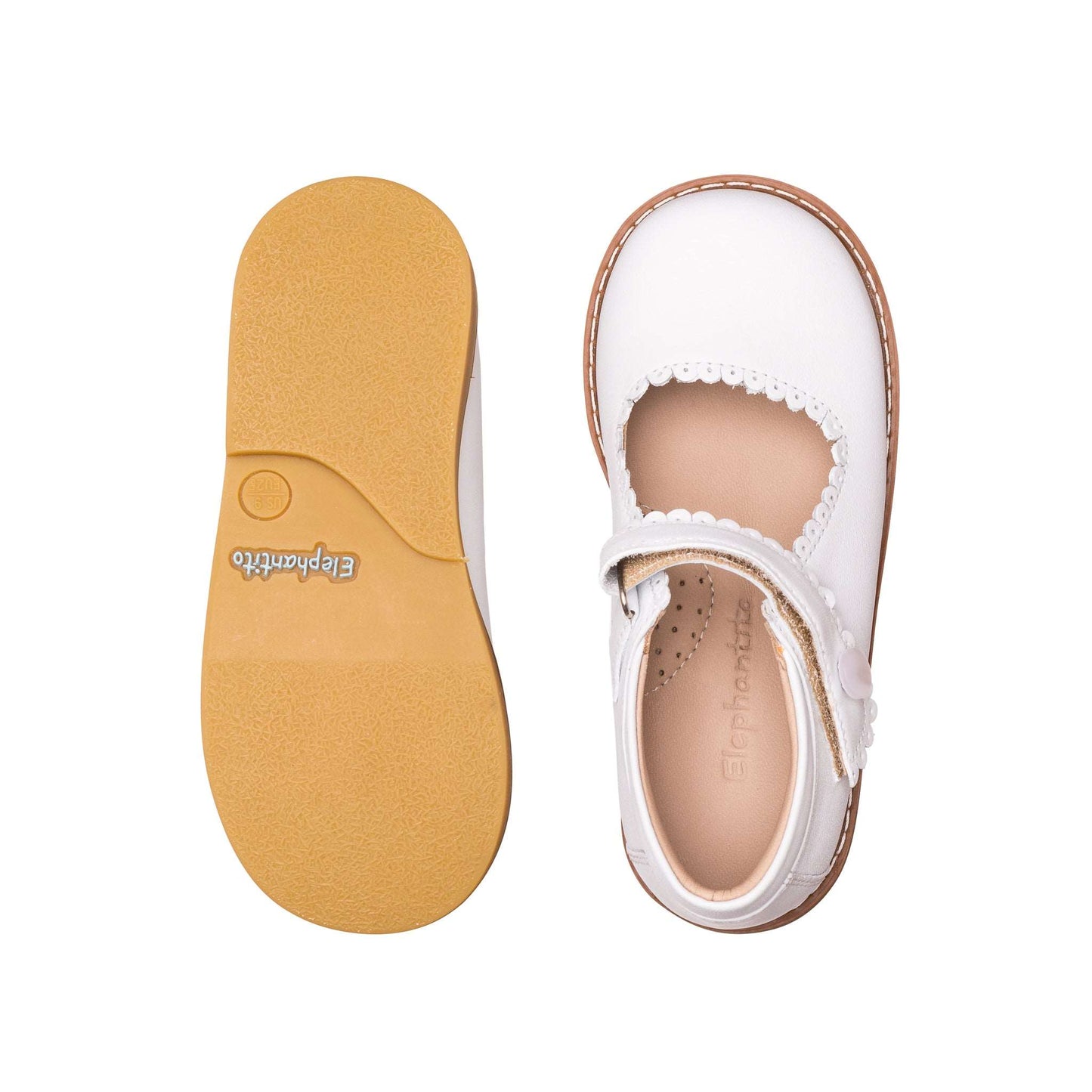 White leather girls' Mary Jane shoe with scalloped edges and tan rubber sole.