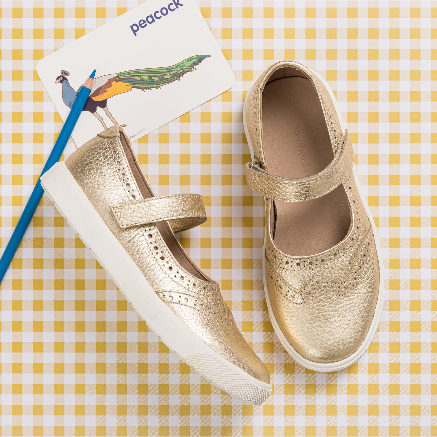 Gold leather Mary Jane sneaker for girls with perforated details and white rubber sole.