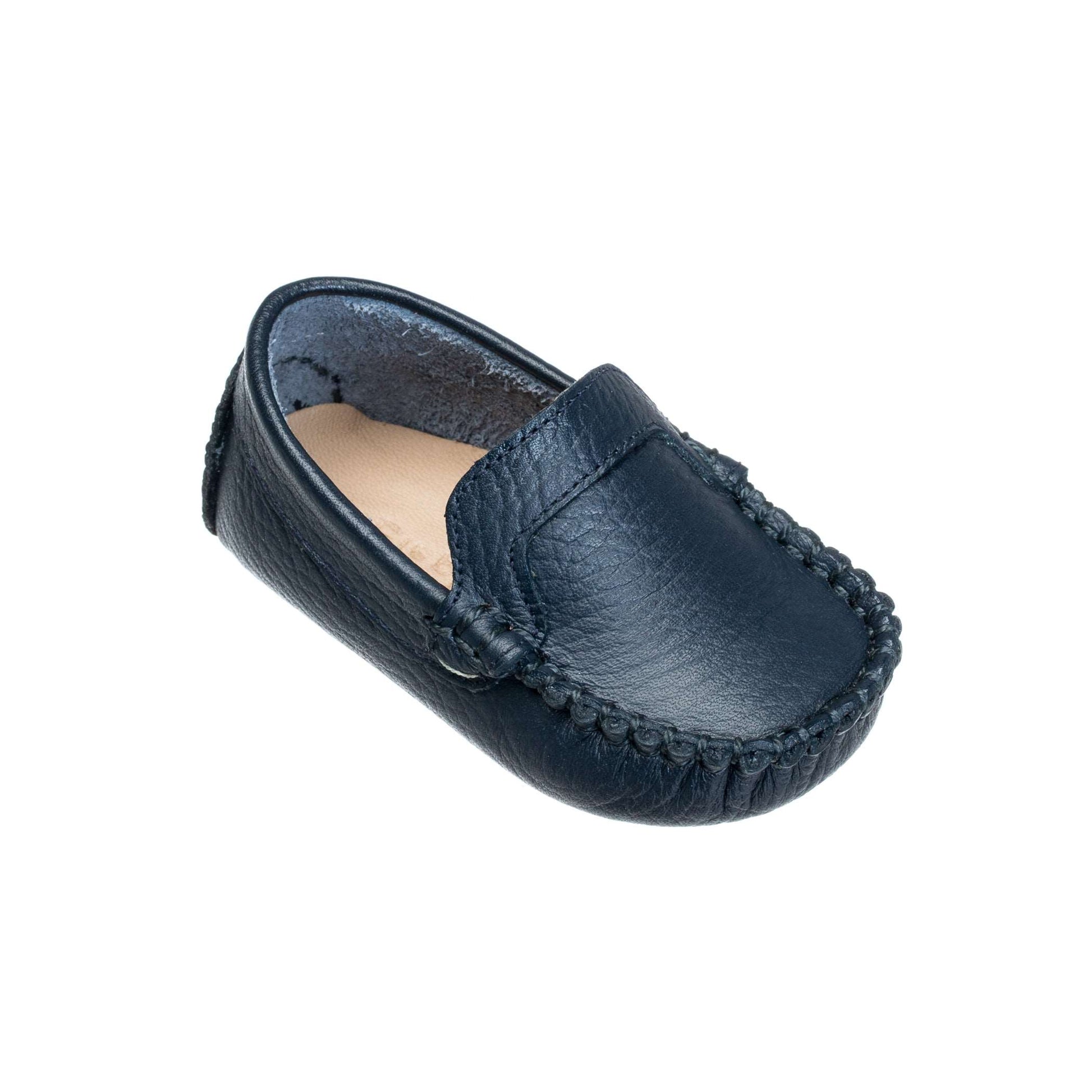 Navy blue leather baby moccasin with stitched detailing and soft sole.