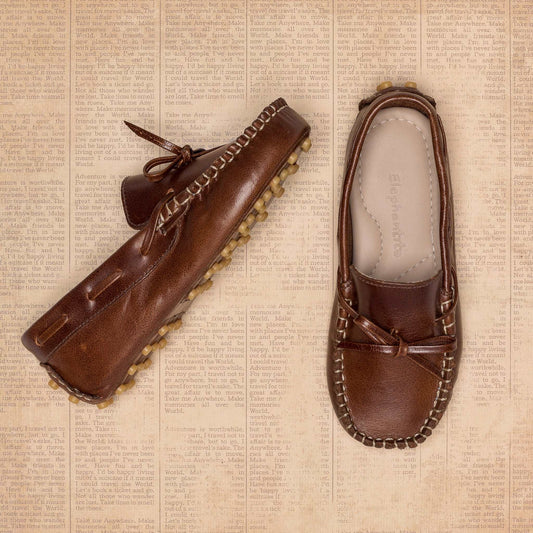 Brown toddler driver loafers with bow detail and textured rubber sole in side and top view.