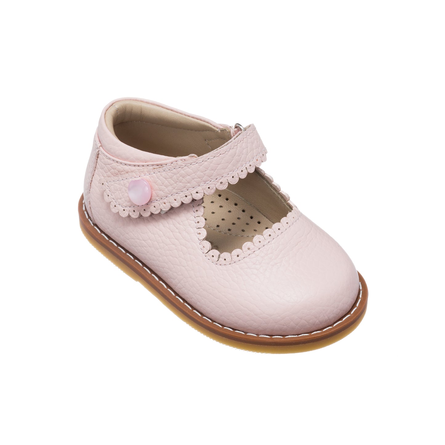Pink toddler Mary Jane shoe with scalloped strap and button detail, perforated insole, tan sole.