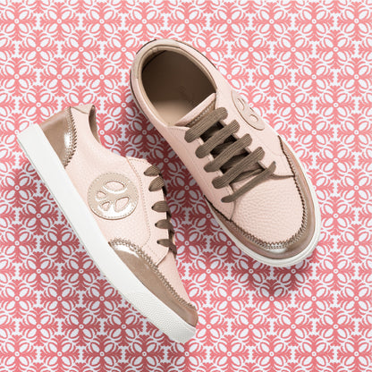 Textured pink children's sneakers with metallic rose gold accents and brown laces on white soles.