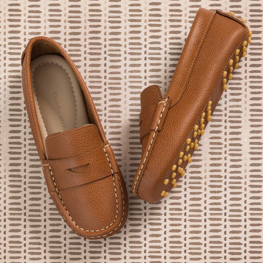 Tan leather children's driver loafers with stitched details and rubber pebble soles.