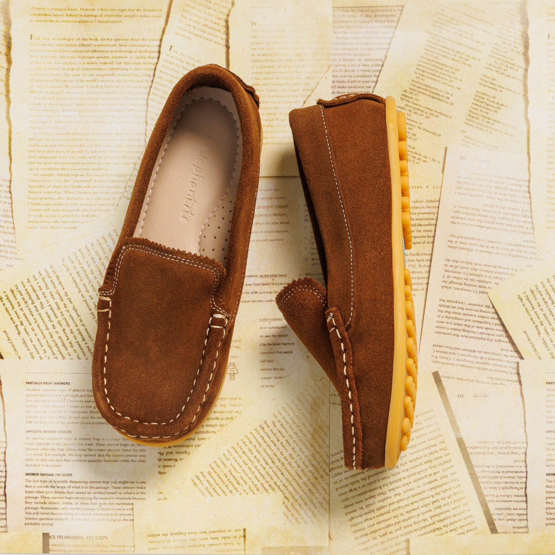 Chestnut brown suede toddler moccasin with stitched detailing and rubber sole.