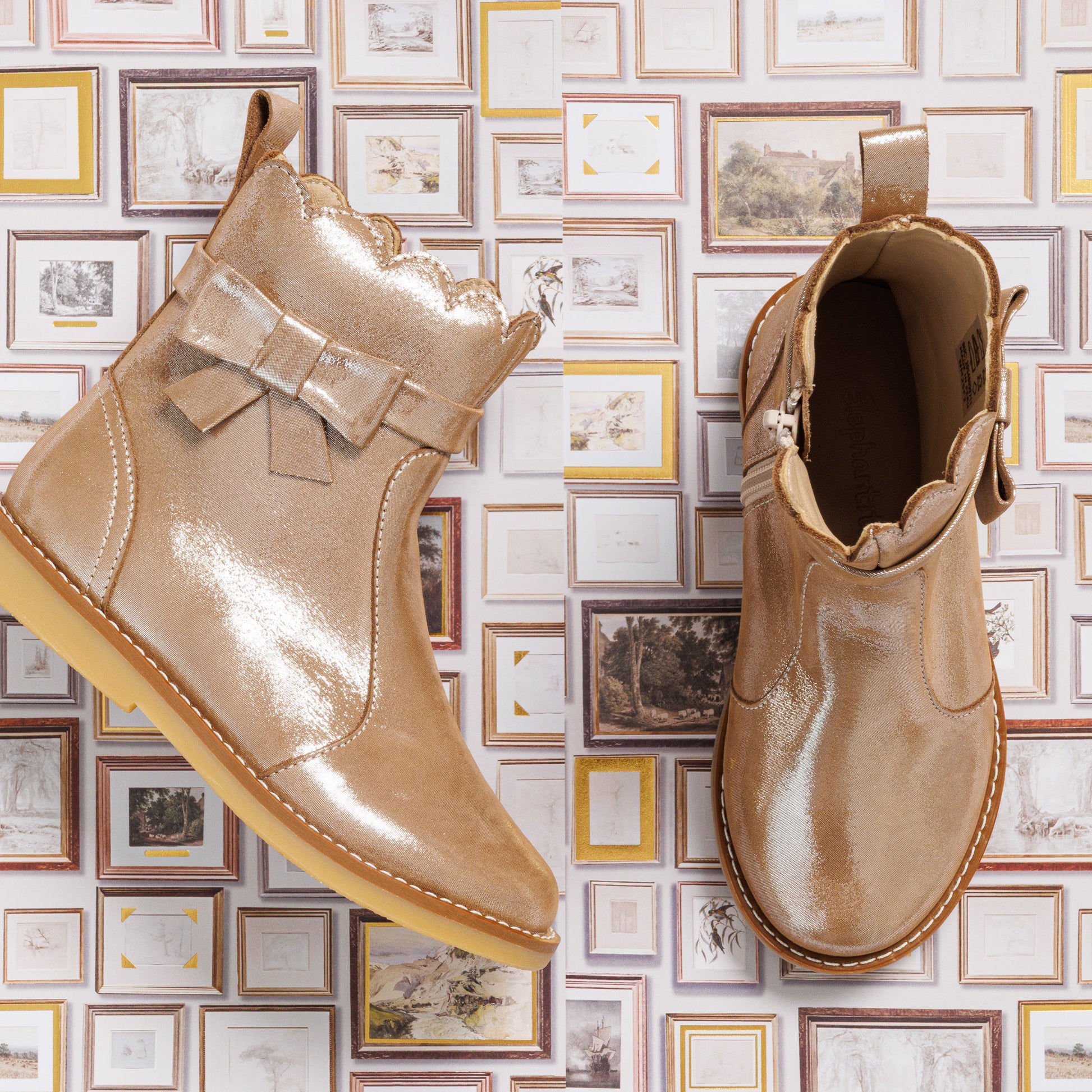 Shiny blush pink toddler booties with scalloped edges and decorative bow on side.