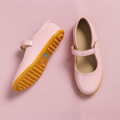Soft pink toddler Mary Jane shoes with adjustable strap and textured tan rubber sole.